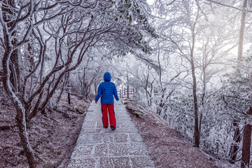 Young woman on the small road in Huangshan National park.