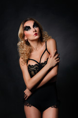 Fototapeta na wymiar Fashion model in black underwear with art make-up