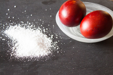Easter eggs, painted with onion husks. .Salt is scattered on the stone.