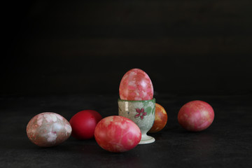 Still llife from many bright dyed easter eggs  on the dark background