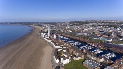 Fototapeta na wymiar Editorial SWANSEA, UK - APRIL 19, 2017: An aerial view of the Swansea City showing the marina, coastal housing, Leisure centre, Swansea market, County Hall and Meridian Tower. 