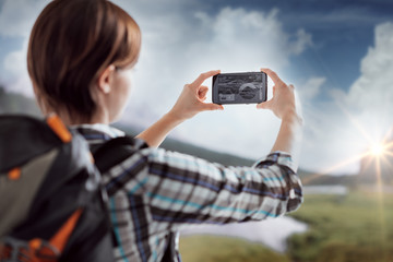 Hiker taking pictures with a smartphone