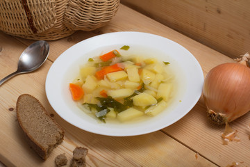Vegetable soup on a wooden rustic table