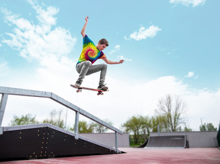 Skater jumping over handrail in skatepark © guteksk7