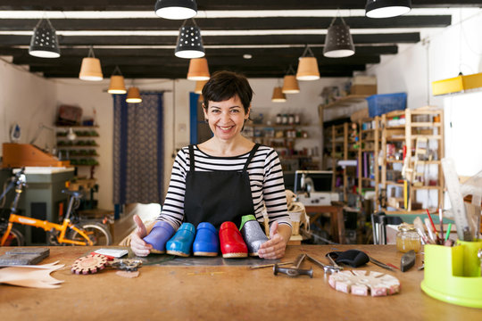 Portrait of confident shoemaker in her workshop