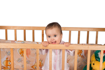 Sad Infant child baby girl toddler in wooden bed on white background