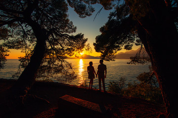 Silhouettes at sunset on the beach in Montenegro