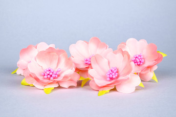 Beautiful artificial flowers on colourful background