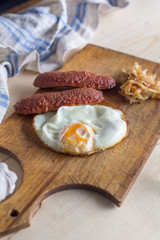 fried eggs with sausages and fried cabbage