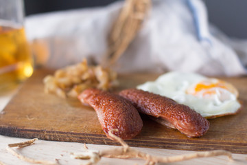 fried eggs with sausages and fried cabbage