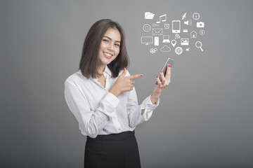 Beautiful business Woman using smartphone on grey background