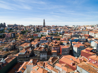 Fototapeta na wymiar Aerial view of orange rooftops and historical buildings of the old city and Clerigos church tower of Porto, Portugal