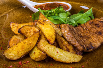 Meat, fried potatoes, and greens