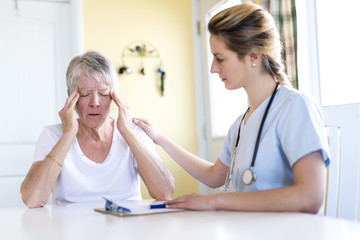 Senior woman with her caregiver at home