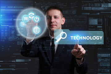 Business, Technology, Internet and network concept. Young businessman working on a virtual screen of the future and sees the inscription: Technology