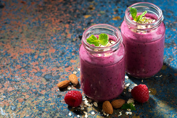 healthy berry smoothie in a bottle on a dark background