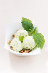 pistachio ice cream in a bowl, vertical