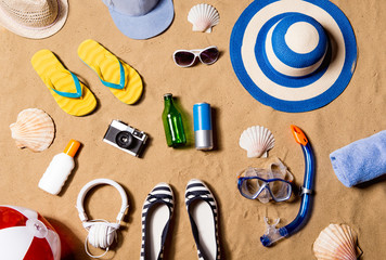Fototapeta na wymiar Summer vacation composition. Sandals, hat and other stuff agains