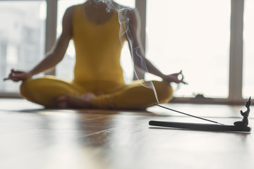 Female yogi meditating in aroma atmosphere