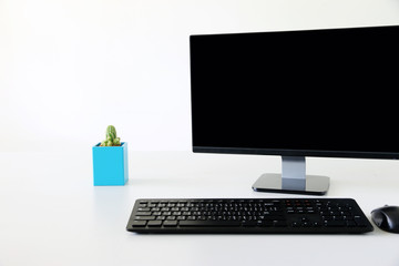 Computer monitor on the table ,background white Office.copy space.