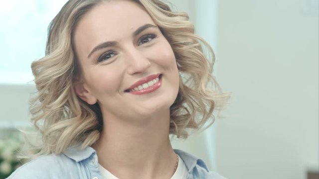 Beauty portrait of beautiful blonde woman smiling at camera