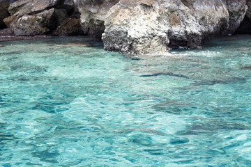 Sea near the rocky shore. Traveling near the island.