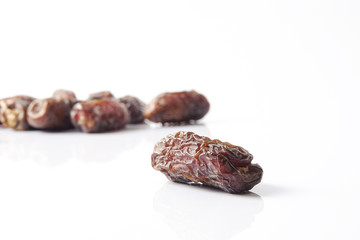 Date fruits on white background. Selective focus.