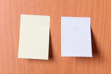 Empty sheets of paper on a wooden wall