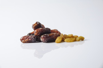 Dates and raisin isolated on white.