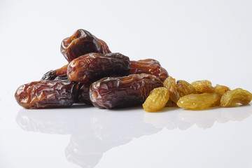 Dates and raisin isolated on white.