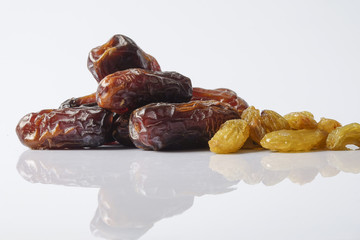Dates and raisin isolated on white.