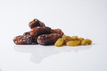 Dates and raisin isolated on white.