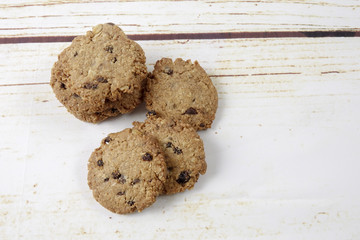 Chocolate chip cookies on old wooden table
