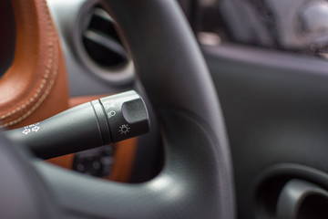 Obraz na płótnie Canvas Car door interior with lamp switch control stick