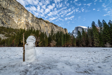 Snowman at Yosemite Valley during winter with Half Dome on background - Yosemite National Park, California, USA