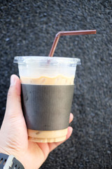Iced coffee with straw in plastic cup