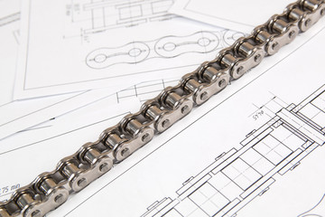 Obraz premium Driving roller chain and technical engineering drawings. Mechanical engineering, technology of metal processing.