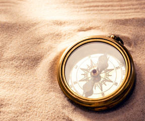 Fototapeta na wymiar Golden compass with beach sand