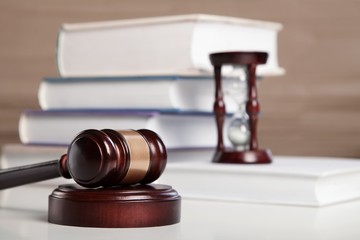 Wooden gavel and books.