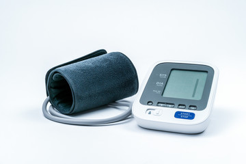 Automatic portable blood pressure machine with arm cuff isolated on white with copy space, studio...