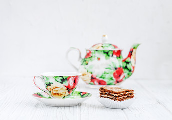 Colored tea service and cake on a wooden table. The concept of beverages and food.
