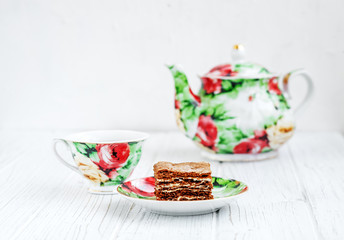 Cup of tea and cake on a wooden table. The concept of beverages and food.
