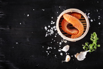 Raw salmon fillets with greens