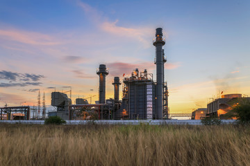 Fototapeta na wymiar Gas turbine electrical power plant at dusk with twilight