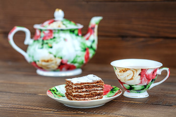 Cup of tea and cake on a wooden background. The concept of beverages and food.