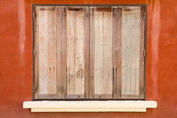 Obraz na płótnie Canvas Old wooden window on orange color concrete background