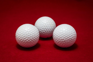 Three golf ball and red flannel background