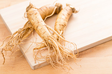 Fresh ginseng over wooden texture