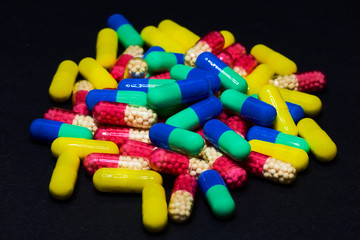 Medicine Pills. Tablets. Capsule.Pharmaceutical medicament, Close-up of pile of blue and green tablets - capsule. Pills and tablets on black background