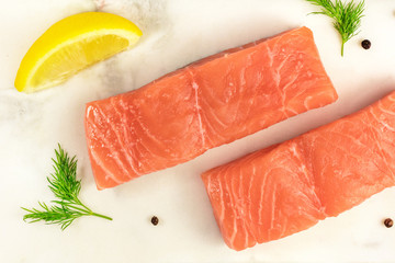 Closeup of slices of salmon with lemon and dill